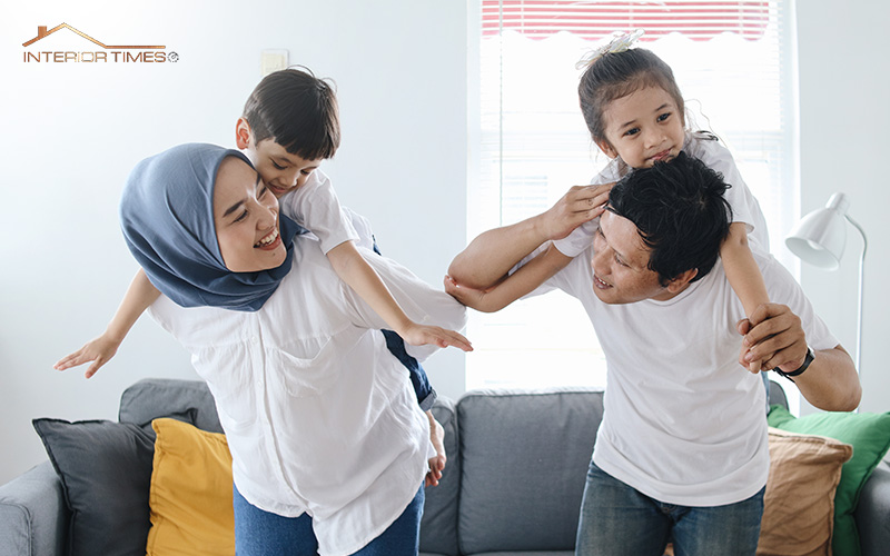 A family where both mother and father are giving their children piggyback ride